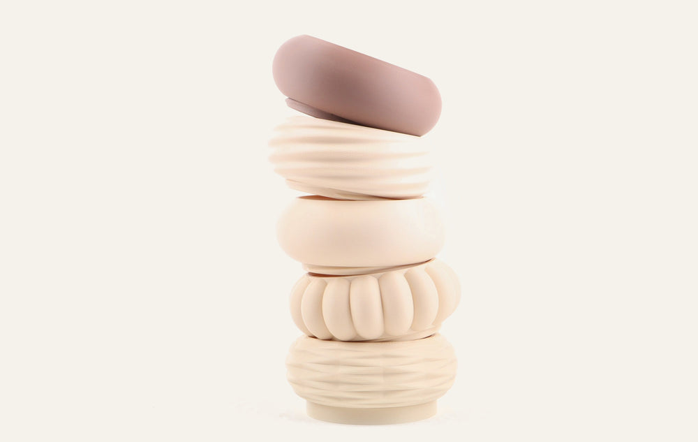 Single stacked modular vase in cream with a mauve top module on a plain cream ground